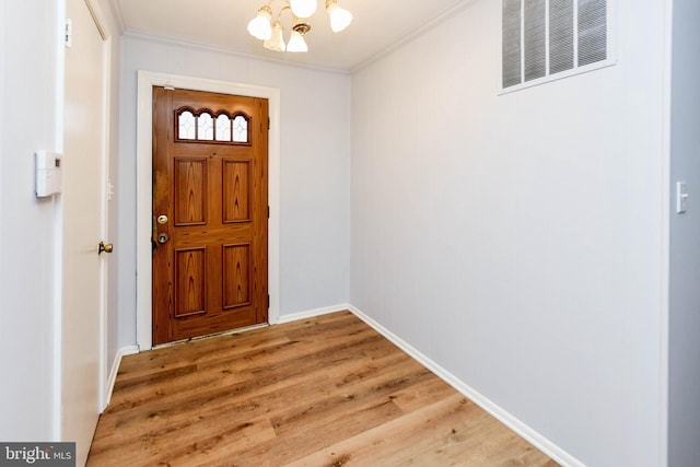 10903 Exeter Ct, Upper Marlboro, MD 20774 - entrance foyer with ornamental molding, a chandelier, light wood finished floors, and baseboards