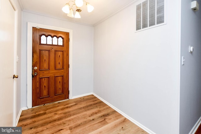 10903 Exeter Ct, Upper Marlboro, MD 20774 - foyer featuring crown molding, a chandelier, light wood finished floors, and baseboards