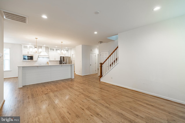 4005 Sweet Azalea Row, Glen Allen, VA 23059 - unfurnished living room featuring a chandelier, baseboards, light wood-style flooring, stairs, and recessed lighting