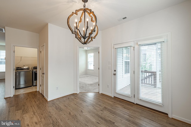 4005 Sweet Azalea Row, Glen Allen, VA 23059 - unfurnished dining area featuring washing machine and clothes dryer, wood finished floors, a chandelier, and baseboards