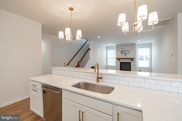 4005 Sweet Azalea Row, Glen Allen, VA 23059 - kitchen featuring a chandelier, a sink, dishwasher, light wood finished floors, and white cabinetry