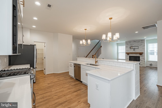 4005 Sweet Azalea Row, Glen Allen, VA 23059 - kitchen featuring stainless steel appliances, a sink, light wood-type flooring, a chandelier, and white cabinets