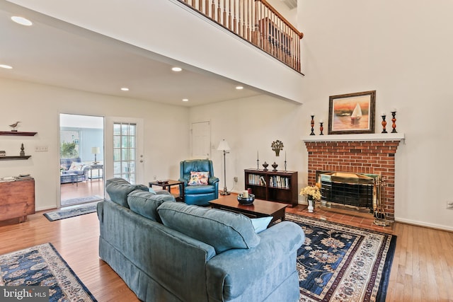 5512 Aspen Dale Ct, Ellicott City, MD 21043 - living area with wood finished floors, a brick fireplace, recessed lighting, and baseboards