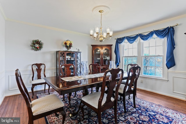 5512 Aspen Dale Ct, Ellicott City, MD 21043 - dining room featuring a chandelier, hardwood / wood-style flooring, crown molding, and a wainscoted wall