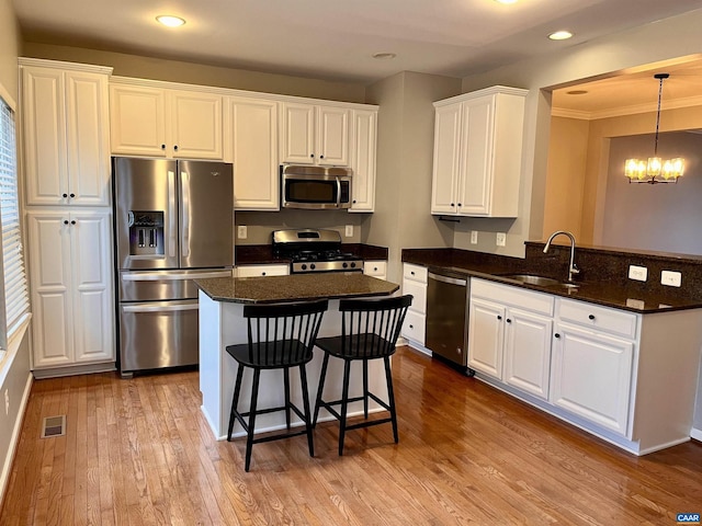 2733 Aldersgate Way, Charlottesville, VA 22911 - kitchen featuring appliances with stainless steel finishes, a sink, white cabinetry, wood finished floors, and a chandelier