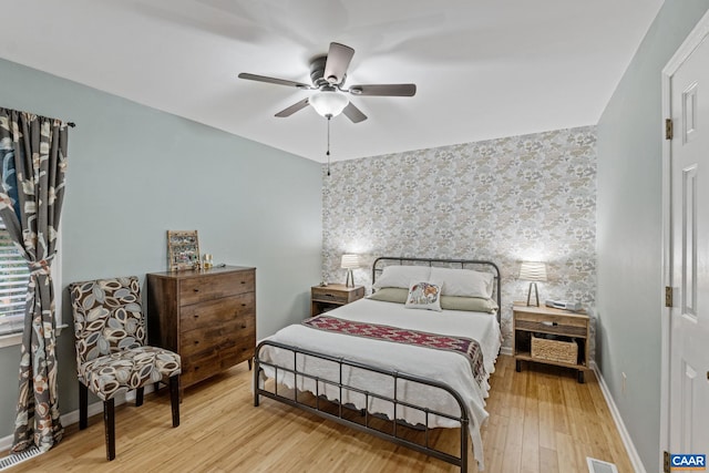 6 Axle Tree Rd, Palmyra, VA 22963 - bedroom featuring wallpapered walls, an accent wall, wood finished floors, baseboards, and a ceiling fan