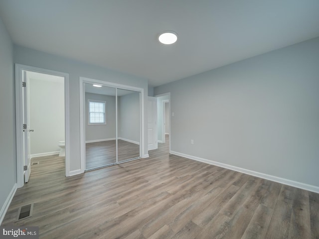 625 Butler Ave, Winchester, VA 22601 - unfurnished bedroom with a closet, wood finished floors, and baseboards
