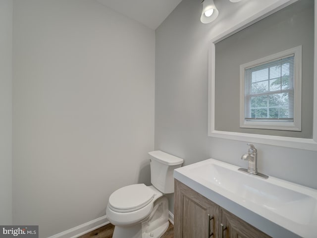 625 Butler Ave, Winchester, VA 22601 - half bathroom featuring baseboards, toilet, vanity, and wood finished floors