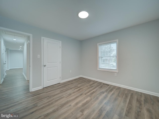 625 Butler Ave, Winchester, VA 22601 - unfurnished bedroom with attic access, wood finished floors, and baseboards