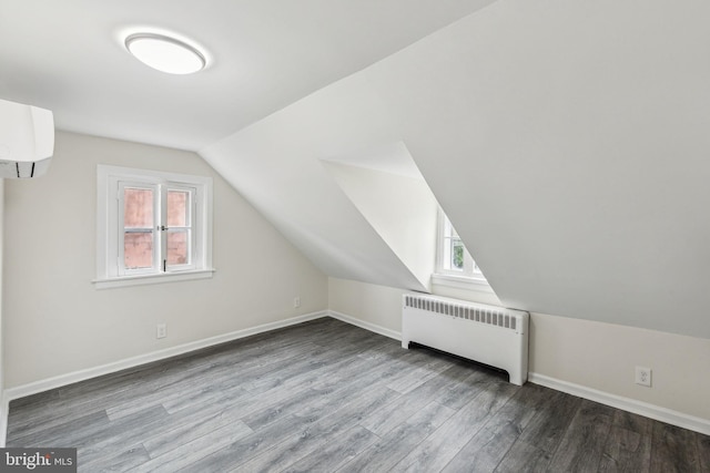 106 Bainbridge St, Philadelphia, PA 19147 - additional living space featuring radiator, healthy amount of natural light, wood finished floors, lofted ceiling, and an AC wall unit