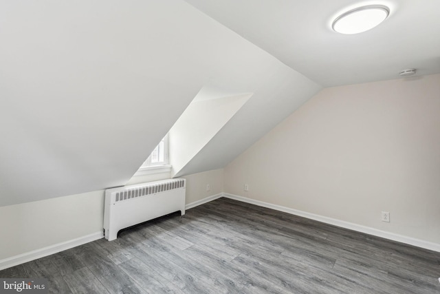 106 Bainbridge St, Philadelphia, PA 19147 - additional living space with radiator heating unit, dark wood-type flooring, lofted ceiling, and baseboards