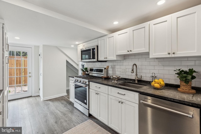 106 Bainbridge St, Philadelphia, PA 19147 - kitchen with appliances with stainless steel finishes, a sink, decorative backsplash, white cabinetry, and recessed lighting