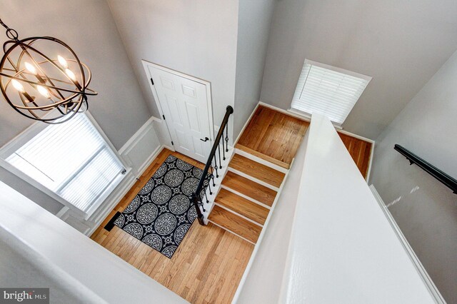 812 Red Rock Cir, Royersford, PA 19468 - stairway with a chandelier, wood finished floors, and a wainscoted wall