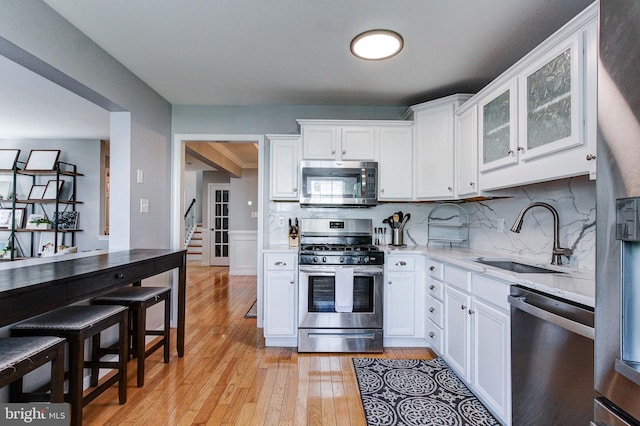 812 Red Rock Cir, Royersford, PA 19468 - kitchen with appliances with stainless steel finishes, a sink, light wood finished floors, and white cabinetry