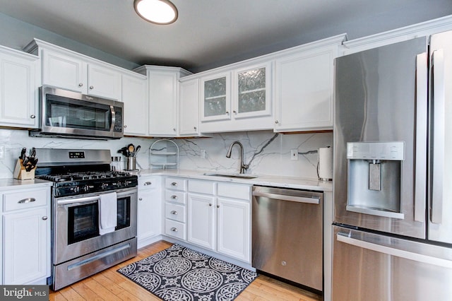 812 Red Rock Cir, Royersford, PA 19468 - kitchen featuring appliances with stainless steel finishes, a sink, light wood-style floors, and white cabinets