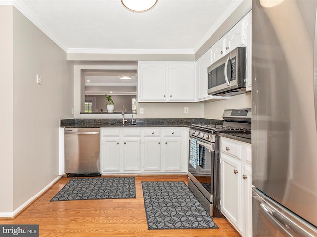 20523 Staffordshire Dr, Germantown, MD 20874 - kitchen with stainless steel appliances, a sink, ornamental molding, white cabinets, and light wood-style flooring