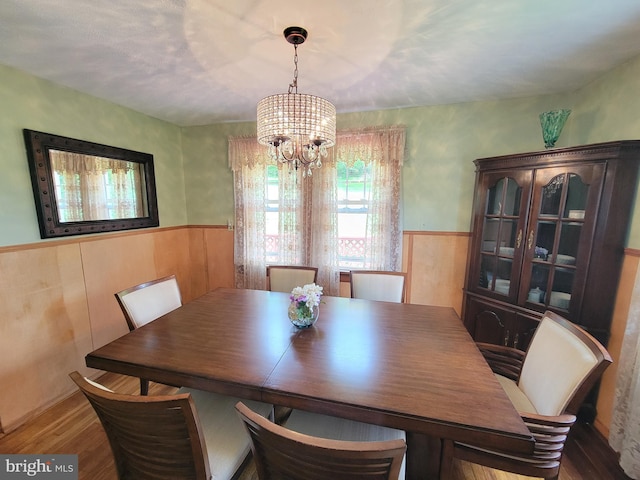 1221 Valley View Rd, Bellefonte, PA 16823 - dining room featuring a chandelier, wainscoting, wood finished floors, and wooden walls