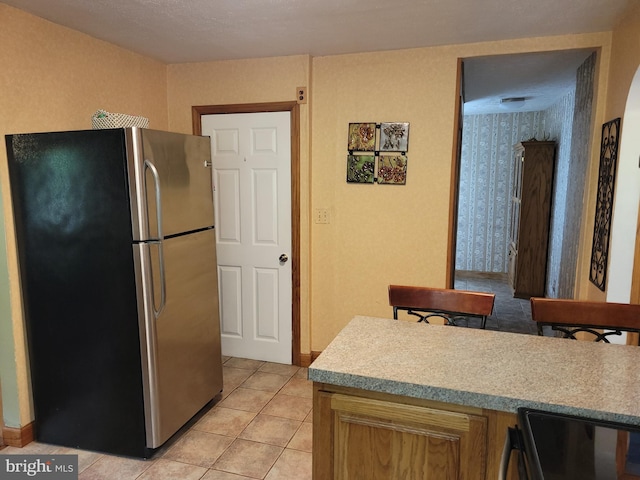 1221 Valley View Rd, Bellefonte, PA 16823 - kitchen featuring freestanding refrigerator, stove, light countertops, light tile patterned floors, and baseboards