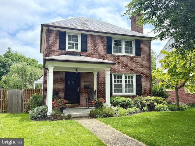 4407 Sedgwick Rd, Baltimore, MD 21210 - view of front facade with brick siding, a chimney, and covered porch