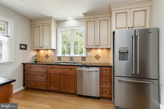 4407 Sedgwick Rd, Baltimore, MD 21210 - kitchen with stainless steel appliances, cream cabinetry, dark countertops, tasteful backsplash, and recessed lighting