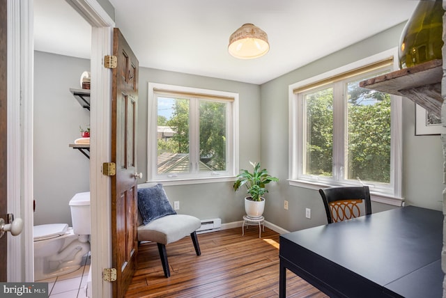 4407 Sedgwick Rd, Baltimore, MD 21210 - home office featuring a baseboard radiator, plenty of natural light, and wood finished floors