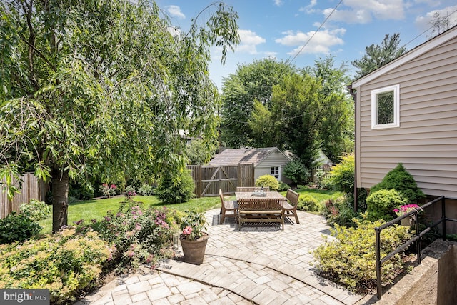 4407 Sedgwick Rd, Baltimore, MD 21210 - fenced backyard with a patio, outdoor dining area, and an outdoor structure