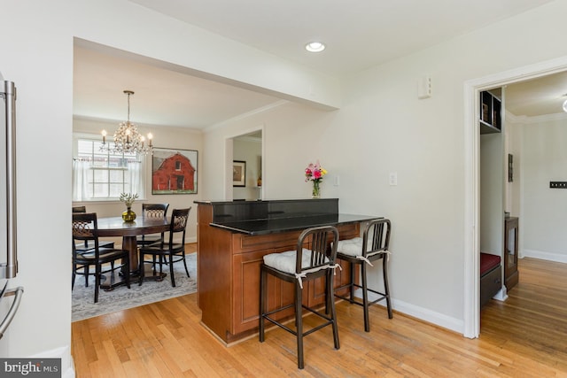 4407 Sedgwick Rd, Baltimore, MD 21210 - bar area featuring light wood-style flooring, ornamental molding, a chandelier, decorative light fixtures, and recessed lighting