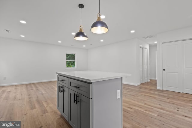 1 Mimosa Ln, Levittown, PA 19054 - kitchen featuring light wood-style flooring, gray cabinets, light countertops, a center island, and hanging light fixtures