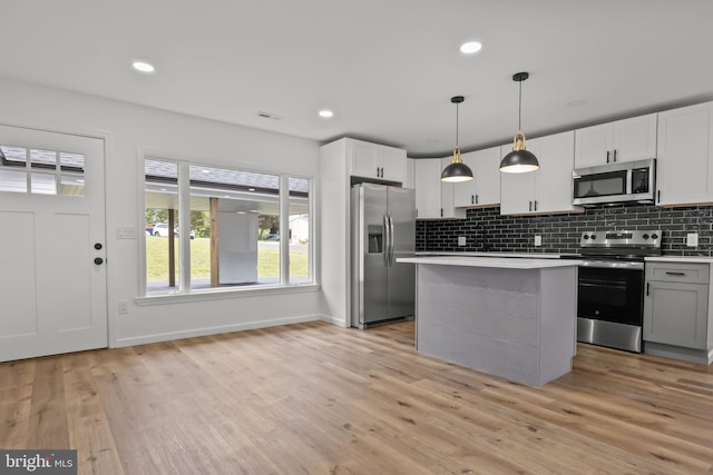1 Mimosa Ln, Levittown, PA 19054 - kitchen with stainless steel appliances, light countertops, tasteful backsplash, baseboards, and light wood finished floors