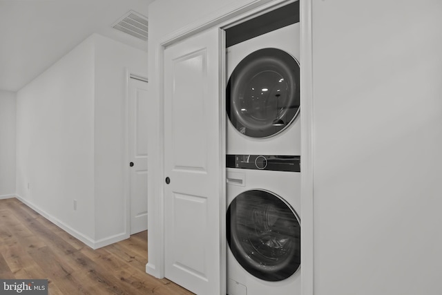 1 Mimosa Ln, Levittown, PA 19054 - washroom featuring stacked washer / drying machine, light wood-style floors, and baseboards