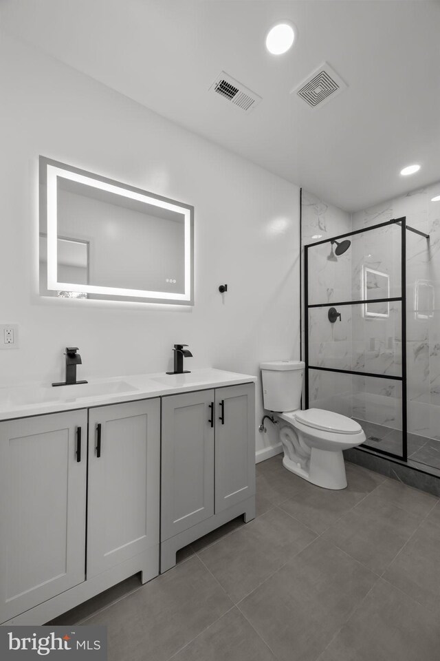 1 Mimosa Ln, Levittown, PA 19054 - bathroom featuring double vanity, toilet, a marble finish shower, tile patterned flooring, and baseboards