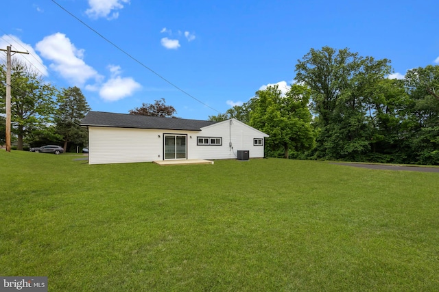 1 Mimosa Ln, Levittown, PA 19054 - back of property featuring a lawn, cooling unit, and a patio