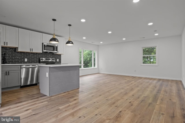 1 Mimosa Ln, Levittown, PA 19054 - kitchen with appliances with stainless steel finishes, decorative backsplash, light wood finished floors, open floor plan, and recessed lighting