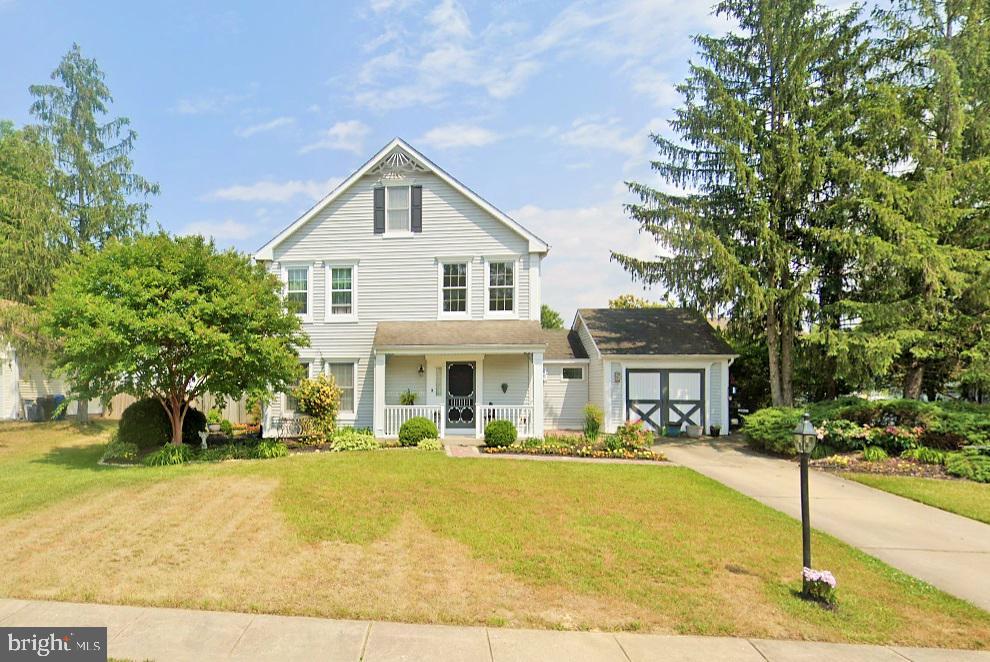 5 Bacon St, Clayton, NJ 08312 - view of front of property with a porch, a front yard, driveway, and an attached garage