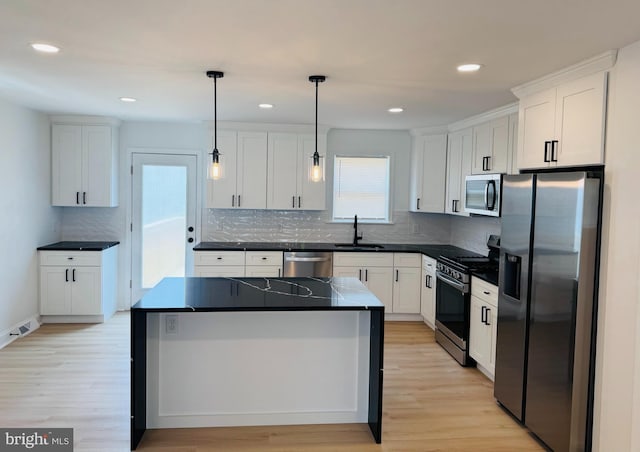 937 E Durard St, Philadelphia, PA 19150 - kitchen with appliances with stainless steel finishes, a sink, white cabinets, light wood-style floors, and recessed lighting