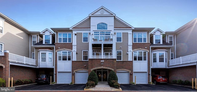 7860 Rolling Woods Ct Unit 402, Springfield, VA 22152 - view of front facade with a garage, driveway, and brick siding