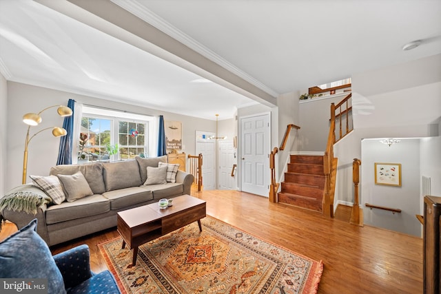 12794 Silvia Loop, Woodbridge, VA 22192 - living room featuring wood finished floors, a chandelier, and crown molding