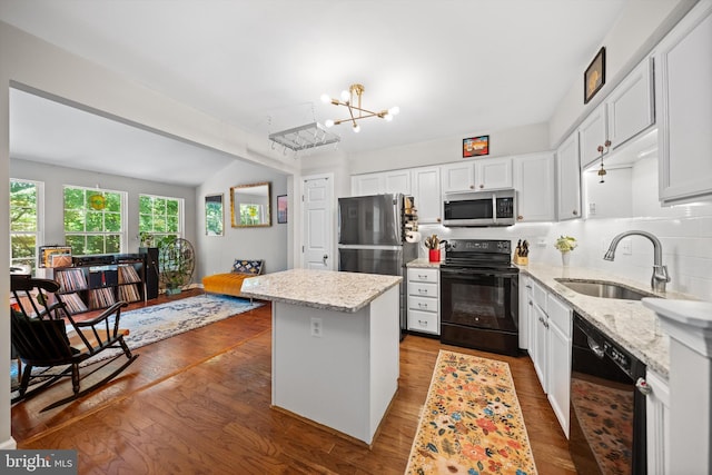 12794 Silvia Loop, Woodbridge, VA 22192 - kitchen featuring black appliances, a chandelier, a center island, and white cabinetry