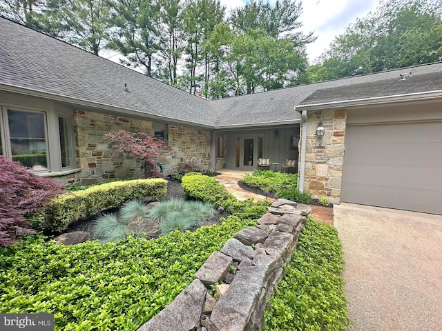 5 Tall Tree Ct, Baltimore, MD 21208 - property entrance with stone siding, roof with shingles, a garage, and driveway