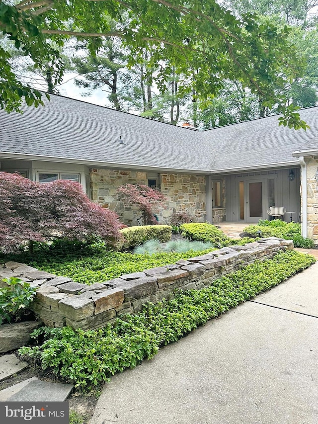5 Tall Tree Ct, Baltimore, MD 21208 - view of front facade featuring stone siding, roof with shingles, and covered porch