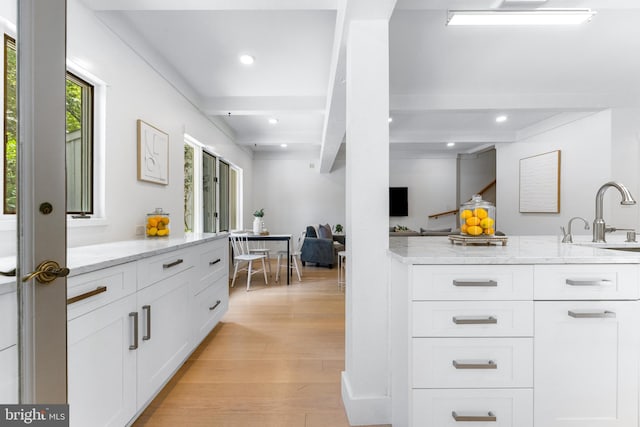 5 Tall Tree Ct, Baltimore, MD 21208 - kitchen featuring light wood-style flooring, white cabinets, light stone countertops, beamed ceiling, and recessed lighting