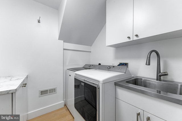 5 Tall Tree Ct, Baltimore, MD 21208 - washroom with cabinet space, washer and dryer, and light wood-style flooring