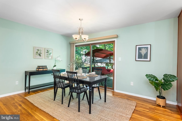 5305 Thunder Hill Rd, Columbia, MD 21045 - dining space with wood finished floors, a chandelier, and baseboards