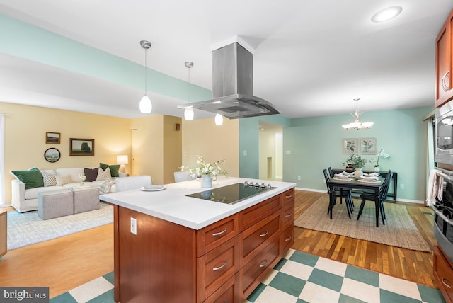 5305 Thunder Hill Rd, Columbia, MD 21045 - kitchen with island range hood, black electric cooktop, light countertops, decorative light fixtures, and a kitchen island