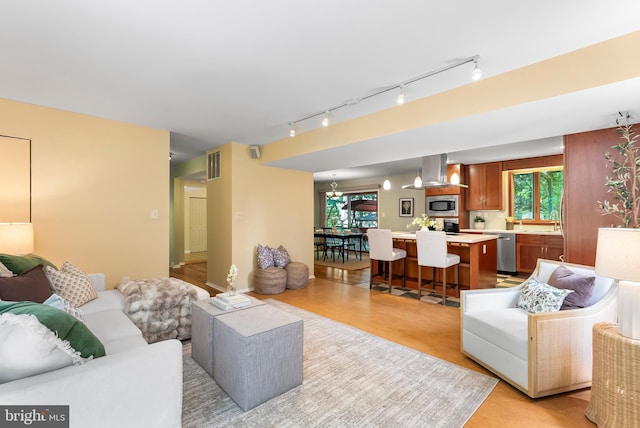 5305 Thunder Hill Rd, Columbia, MD 21045 - living room featuring a chandelier and track lighting