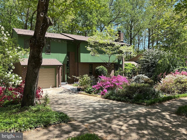 5305 Thunder Hill Rd, Columbia, MD 21045 - view of front of property with a chimney, brick siding, a garage, and driveway