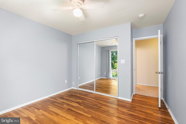 5305 Thunder Hill Rd, Columbia, MD 21045 - unfurnished bedroom featuring wood finished floors, a closet, baseboards, and ceiling fan