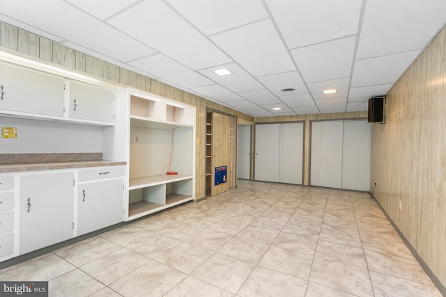 5305 Thunder Hill Rd, Columbia, MD 21045 - basement with wood walls, built in shelves, and a drop ceiling