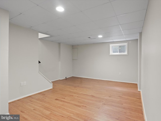 108 Bickel Ct, Sterling, VA 20165 - basement featuring light wood-style flooring, baseboards, and a paneled ceiling