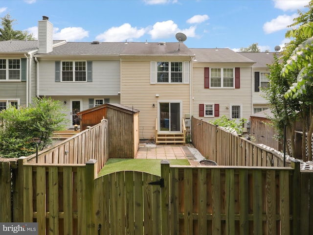 108 Bickel Ct, Sterling, VA 20165 - back of property with a fenced backyard, entry steps, and a gate